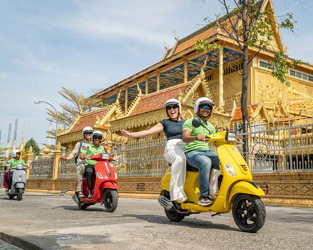 Spin around the Phnom Penh Silk Island in a Vespa